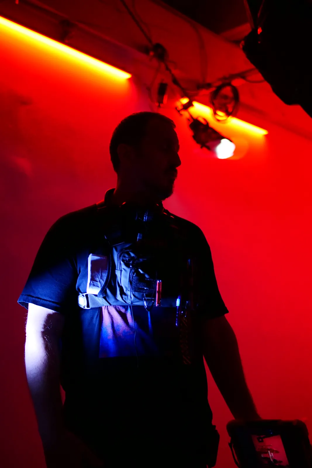 Matt Moeller standing in dramatic red and blue production lighting