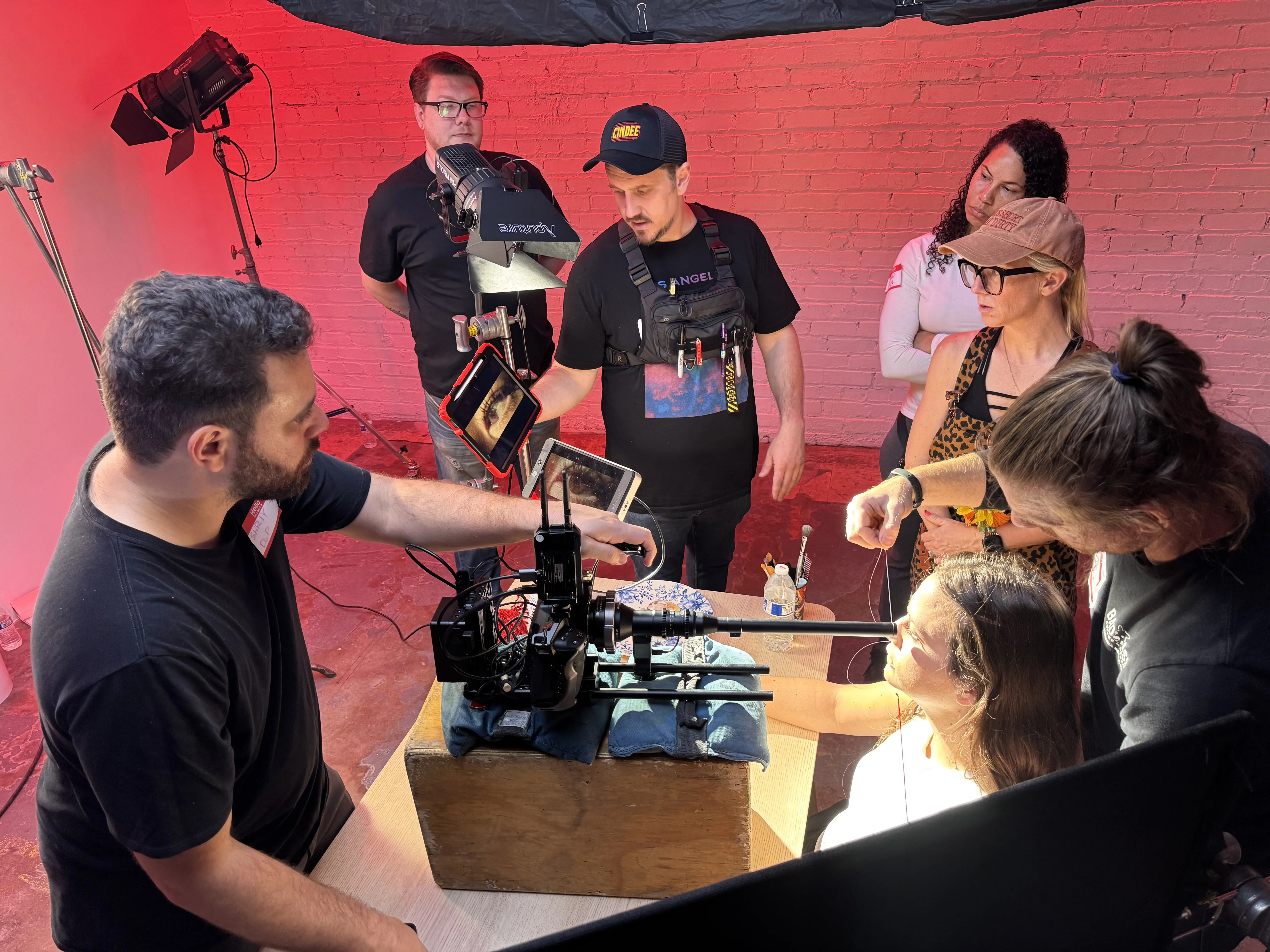 The Inhabitant crew setting up a shot on a red-lit set