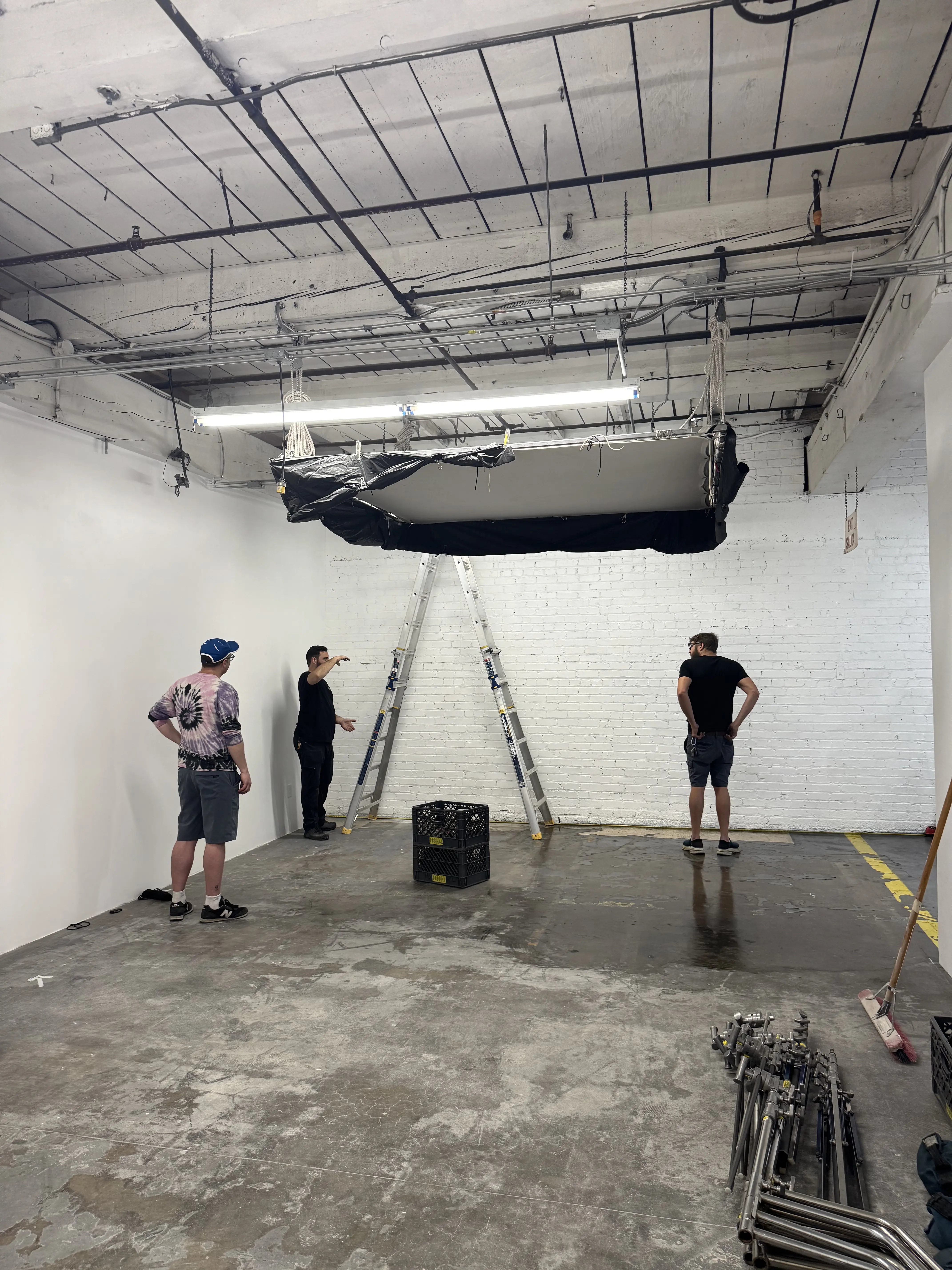 Crew evaluating a suspended rig during production prep